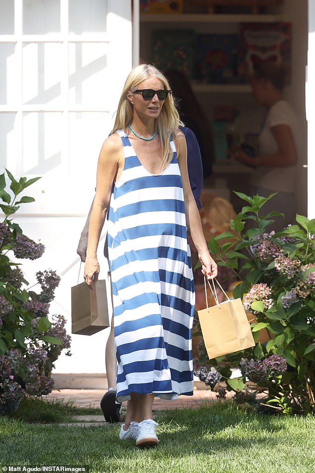 The 51-year-old actress showed off her carefree style in a flowing blue and white striped maxi dress with a low scoop neckline that showed off her cleavage.