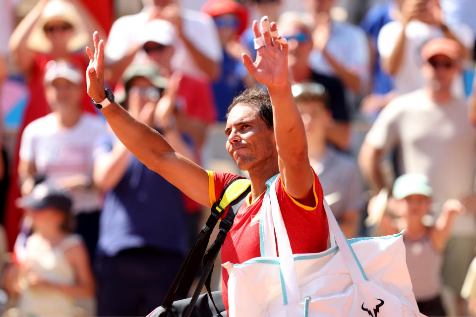 PARIS, FRANCE - JULY 29: Rafael Nadal of Team Spain waves to the crowd after losing to Novak Djokovic of Team Serbia at the end of their Men's Singles second round match on day three of the Paris 2024 Olympic Games at Roland Garros on July 29, 2024 in Paris, France. (Photo by Clive Brunskill/Getty Images)