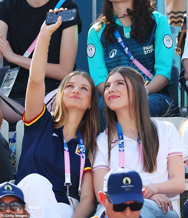 The teenage royals were photographed taking selfies with their mobile phones in the stands.