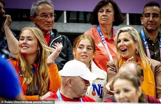 Máxima and her two daughters Amalia (left) and Alexia (center) smile as they watch the match