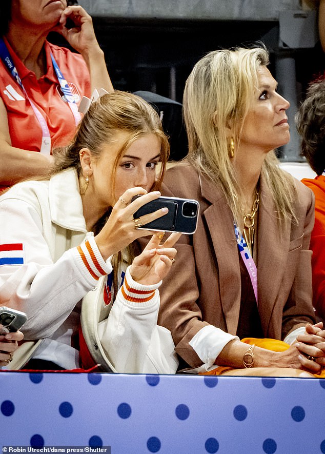 Princess Alexia was photographed taking pictures of the event with her mobile phone.