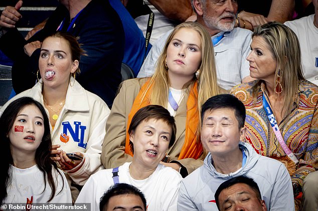 Queen Maxima (pictured, right) looks annoyed as her daughter Princess Alexia (pictured, left) chews gum while watching swimming at yesterday's Olympics.