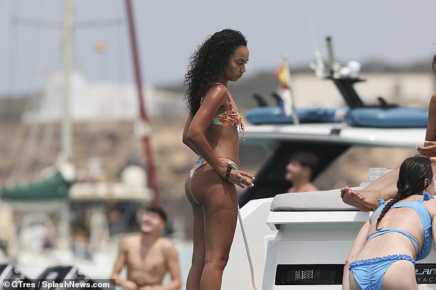 She showed off her sensational physique in a tiny bikini as she lounged on the luxury yacht.