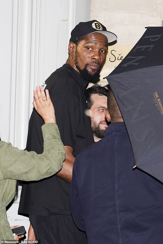 Kevin Durant sports a Boston Bruins cap as he heads out of Siena