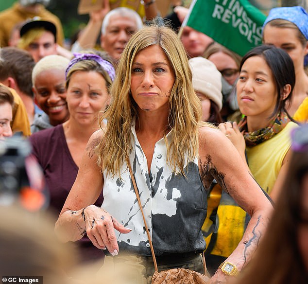 She looked disgusted and made a disgruntled face as she continued filming the chaotic scene while playing fictional TV host Alex Levy and reporting live from the fictional protest.