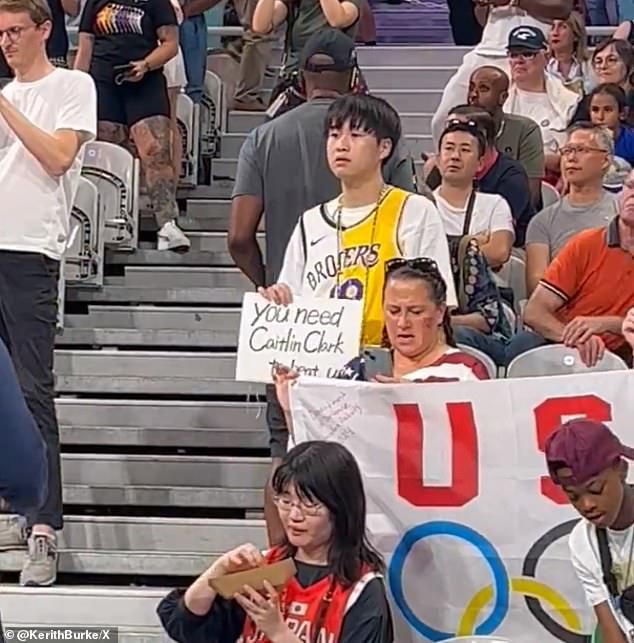 The fan held up a sign reading 'they need Caitlin Clark to beat us' before their match with Japan.