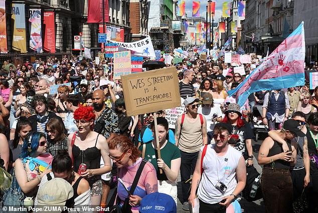 A protester at a Trans Pride march in London on July 27 holds a sign calling on Health and Social Care Secretary Wes Streeting to 