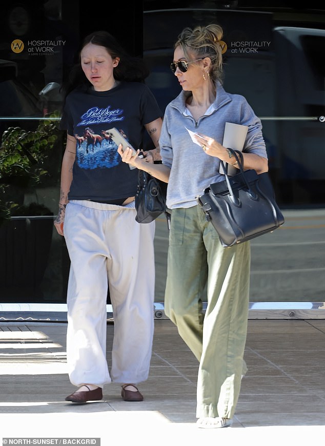 Miley Cyrus' 57-year-old mother kept close to her youngest son, 24, as they were spotted leaving the Encino Financial Center.