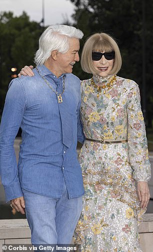 Sporting a shock of silver hair styled in a decidedly 1970s style, the acclaimed director wore a light blue denim button-down shirt, a matching pair of light blue jeans, and a similarly colored tie.