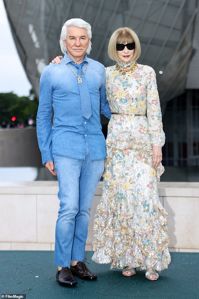 Anna wore a long-sleeved brocade-style dress with a thin gold belt and a pair of silver open-toed shoes.