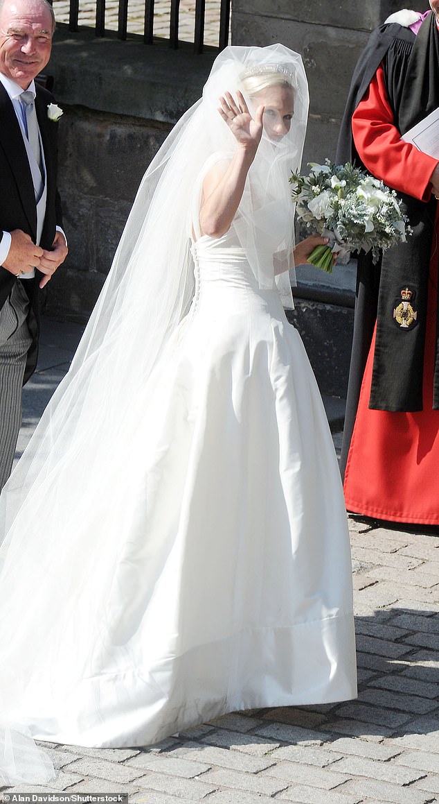 Zara photographed in her long wedding dress made of beautiful ivory silk, with her father, Captain Mark Phillips.