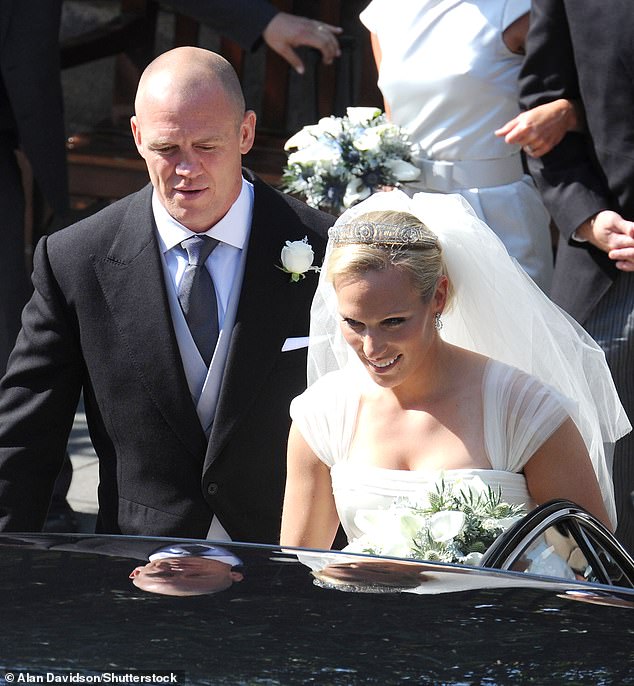 The bride and groom are photographed getting into their limousine after the wedding ceremony.