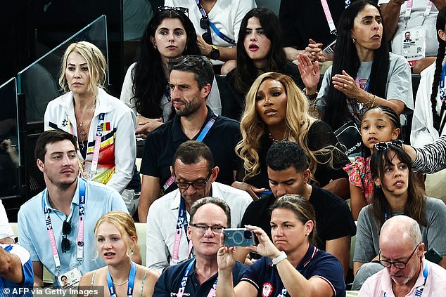 Organizing Committee of the Olympic and Paralympic Games (Cojo) Tony Estanguet (second row C) and former American tennis player Serena Williams (second row CR) await the start of the women's team final of artistic gymnastics