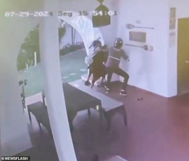 Terrifying CCTV footage shows the robber demanding money from them before grabbing the Brazilian national and trying to drive her away.