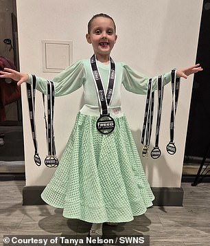 Amelia appears in the photo with her numerous medals.