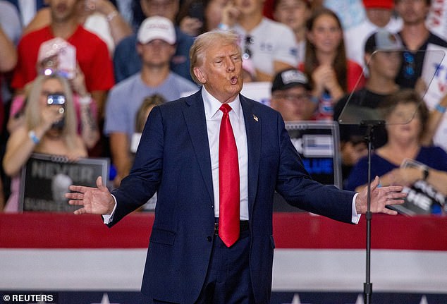 Republican presidential candidate Trump gestures during a rally with his vice presidential running mate, U.S. Sen. J.D. Vance, in St. Cloud, Minnesota, July 27, 2024.