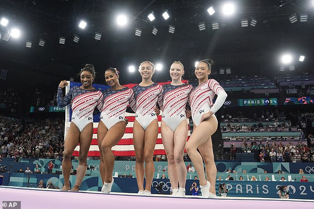 The team celebrated their gold medal by clutching an American flag, jumping up and down and taking time to pose for photos with fans.