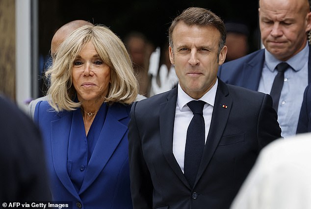 Macron, flanked by his wife Brigitte Macron, leaves after his vote in the second round of France's legislative elections at a polling station in Le Touquet, northern France, July 7, 2024.