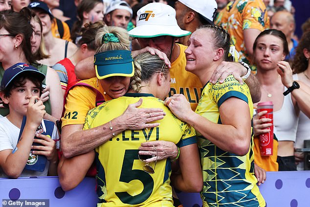 Pictured: The Australian stars are consoled by members of the crowd after going from being one of the favourites to take home the gold to leaving Paris empty-handed.