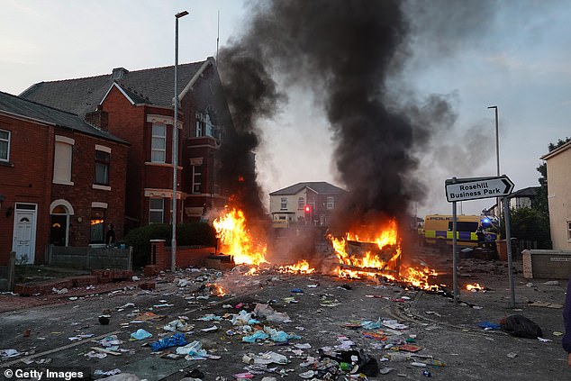 Southport ablaze: A street near a mosque caught fire as violent thugs took to the streets last night