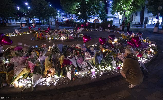 In stark contrast to the unrest on the streets, there was a sense of tranquility at the vigil site as night fell.