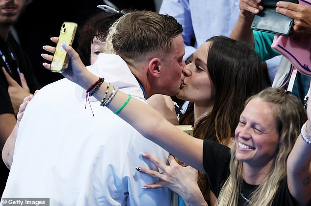 Holly was in the crowd with Adam's three-year-old son George on Sunday when the Olympic swimmer came second when Italian underdog Nicolo Martinenghi beat him in the 100m breaststroke final by just 0.02 seconds.