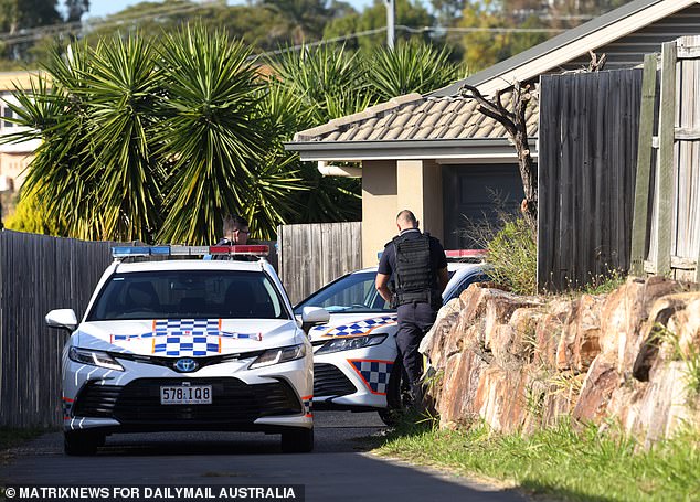 Police are pictured outside Sant's home in Goodna on Wednesday