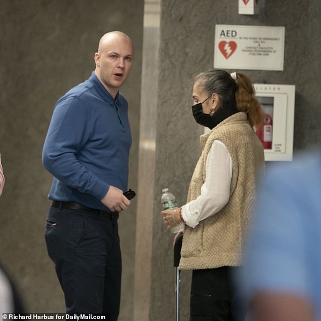 Rodriguez stands with his mother inside the Queens courthouse on Monday, ready to face the judge.