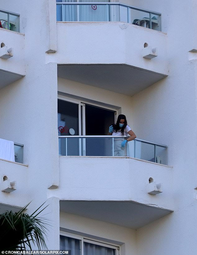 The young woman, who is 20 metres from the seventh floor balcony of her hotel, heads to the roof of a restaurant on the first floor.