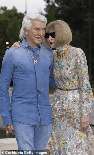 Sporting a shock of silver hair styled in a decidedly 1970s style, the acclaimed director wore a light blue denim button-down shirt, a matching pair of light blue jeans, and a similarly colored tie.