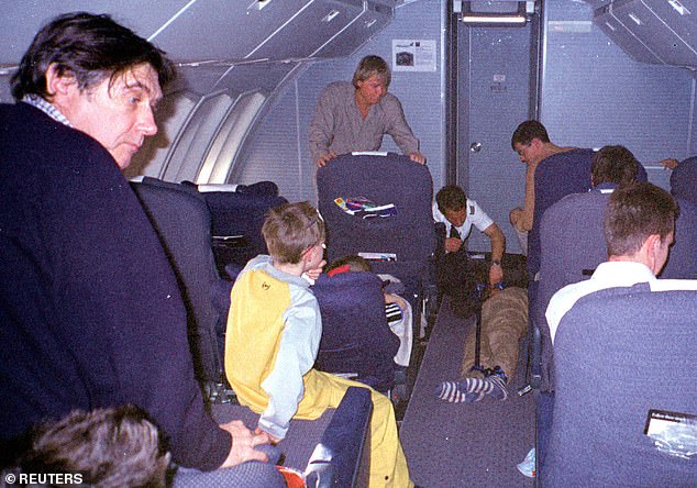 British pop singer Bryan Ferry (left) watched as British Airways flight crew prepared to remove Kenyan hijacker Paul Kefa Mukonyi, 27, from his Kenya-bound flight.