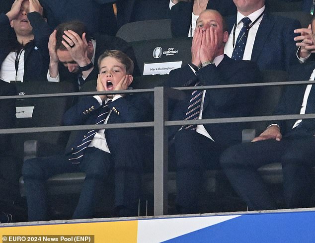 Prince George holds his face in his hands alongside his father Prince William as they watch England lose the Euro 2024 final to Spain in Berlin.