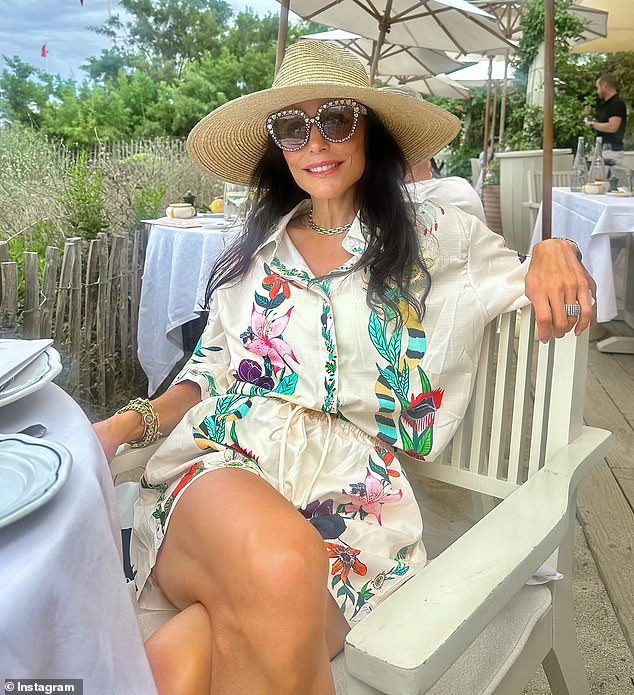 In another snap, she posed in a summery floral print jumpsuit as she enjoyed brunch on the beach.