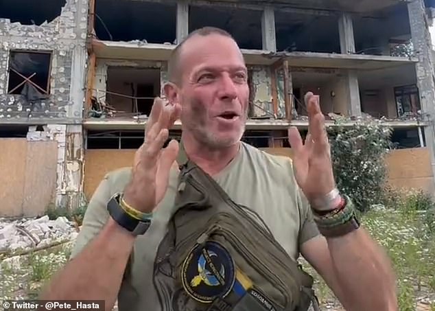 In this screenshot taken from a social media clip, Fouché is seen standing in front of a damaged building in Ukraine.