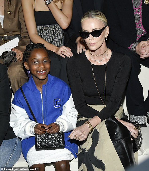 Theron with her daughter August at the Christian Dior Pre-Fall 2024 fashion show in April