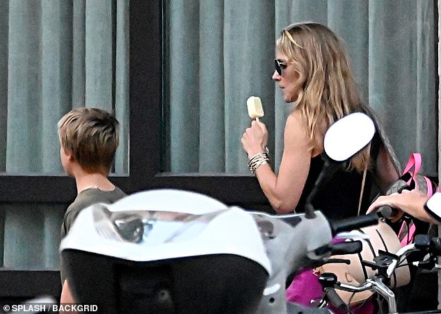 The Spanish-born star, 47, who is visiting family in his home country, licked an ice cream as he took in the sights with his genetically blessed family.