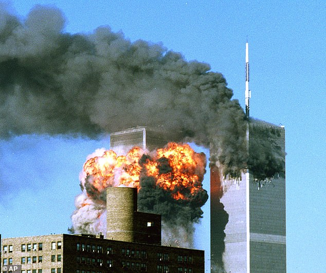 Plumes of smoke rise from the top of One World Trade Center and flames and debris erupt from Two World Trade Center, Tuesday, Sept. 11, 2001.