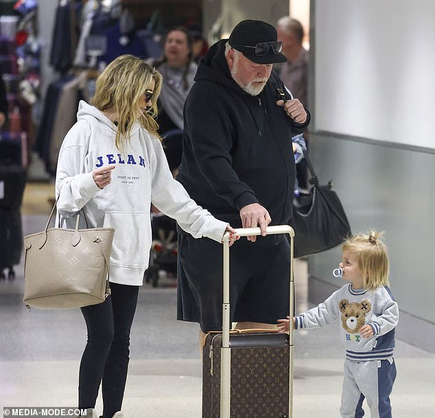 As the family of three headed to the airport, the little boy was seen clutching the handle of a Louis Vuitton carry-on suitcase, seemingly determined to contribute to the family's load.