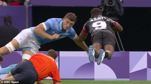 Asati pictured leaping over the try line as referee Duarte (bottom left) watches from the ground.