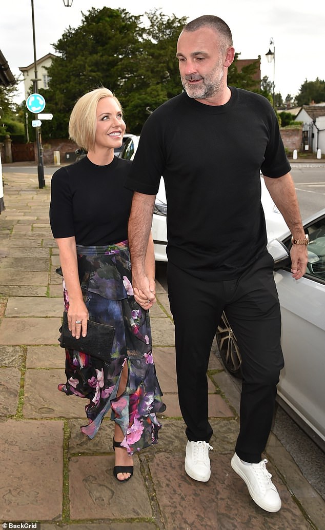 Stephanie looked effortlessly chic in a black crop top that she paired with a high-waisted floral wrap skirt that showed off a glimpse of her toned legs.