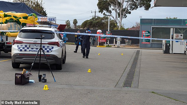 Evidence markers have been placed throughout the 7-Eleven parking lot.