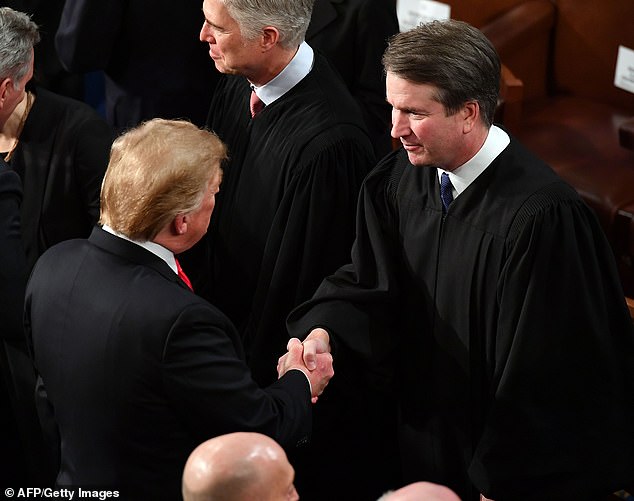 Judge Brett Kavanaugh shakes hands with President Donald Trump before the State of the Union address in 2019. It was his stormy confirmation that helped propel Vance into politics