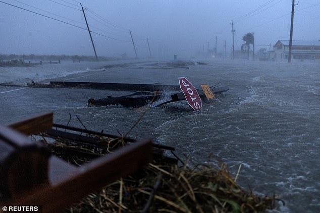 Debris and floodwaters from Hurricane Beryl cover the main road in Surfside Beach, Texas, on July 8, 2024.