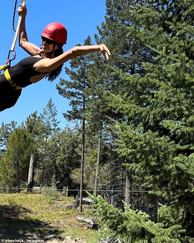 The adventurous city girl posted a photo as she prepared to zipline, wearing a black tank top for the trip through the forest with a red helmet for protection.