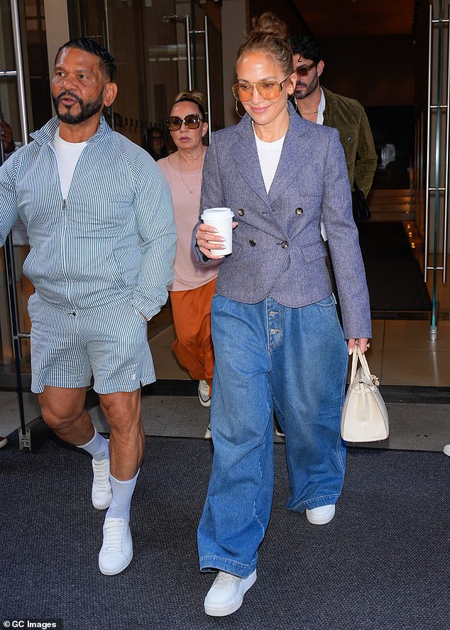 She paired the preppy look with wide-leg button-down jeans and white sneakers.