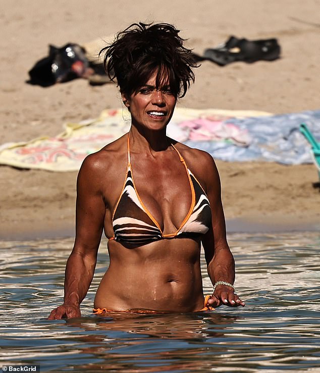 The 56-year-old radio presenter was working on her tan in a vibrant zebra-print two-piece as she enjoyed the sunshine on the Spanish island on Wednesday.