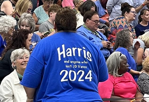 Woman at Harris rally in Wisconsin wearing a t-shirt that says 'Harris and anyone who isn't JD Vance 2024'