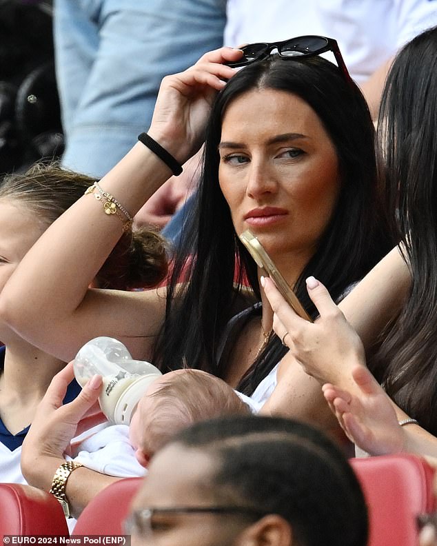 Meanwhile, the footballer's wife Annie Kilner joined him at the game in Dusseldorf (pictured) and watched from the stands while feeding the couple's two-month-old son Rezon.