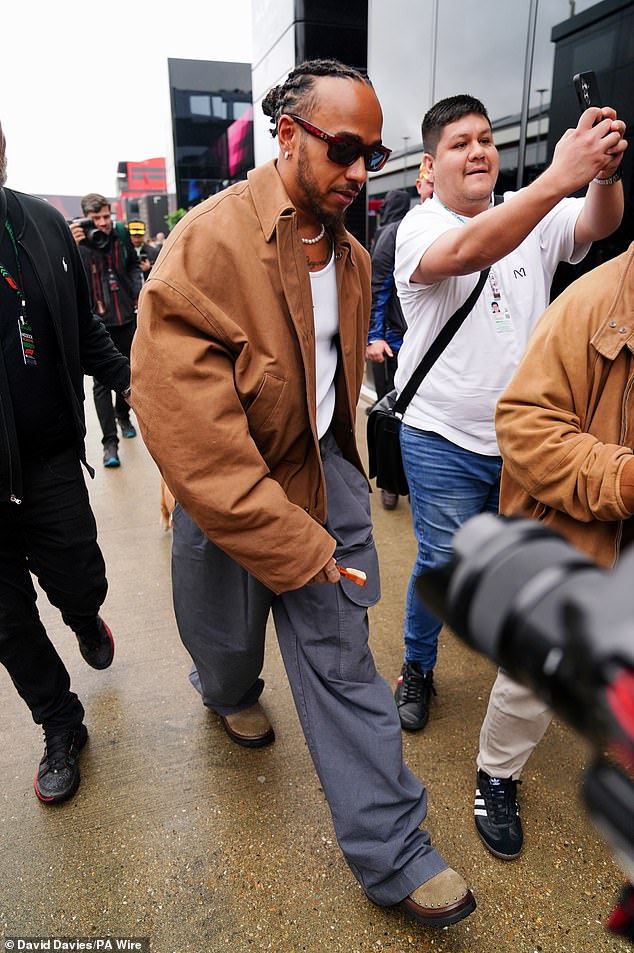 Lewis was seen making his way through the crowd as racing fans tried to get a photo with him.