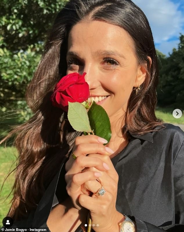 An adorable photo holding a rose allowed Marisa to show off her massive diamond ring.